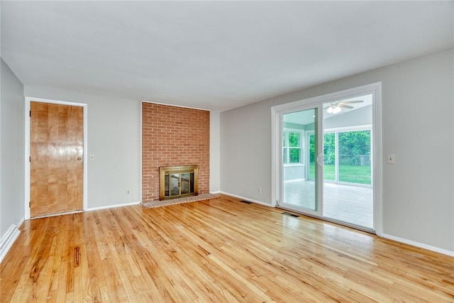 54 Hillary Dr, Chili, NY 14624 - unfurnished living room featuring wood finished floors, a fireplace, and baseboards