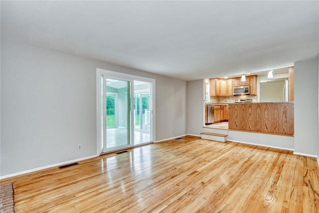 54 Hillary Dr, Chili, NY 14624 - unfurnished living room featuring light wood-style floors and baseboards