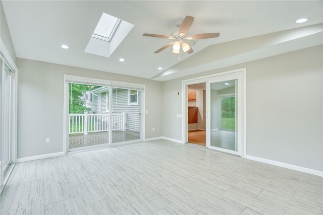 54 Hillary Dr, Chili, NY 14624 - spare room featuring a skylight, vaulted ceiling, a ceiling fan, baseboards, and recessed lighting