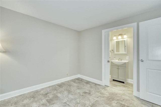 54 Hillary Dr, Chili, NY 14624 - unfurnished bedroom with a sink, baseboards, and connected bathroom