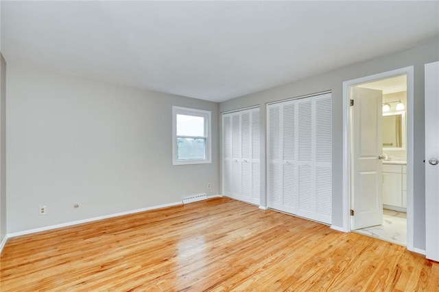 54 Hillary Dr, Chili, NY 14624 - unfurnished bedroom featuring light wood-type flooring, two closets, baseboards, and ensuite bathroom
