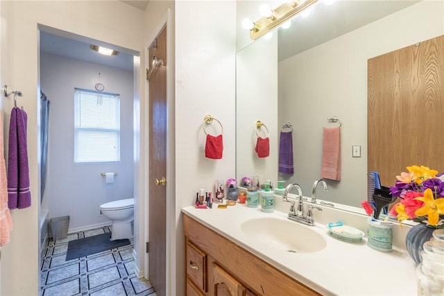 286 Troup St, Rochester, NY 14608 - bathroom featuring vanity, toilet, shower / bath combo, tile patterned flooring, and baseboards