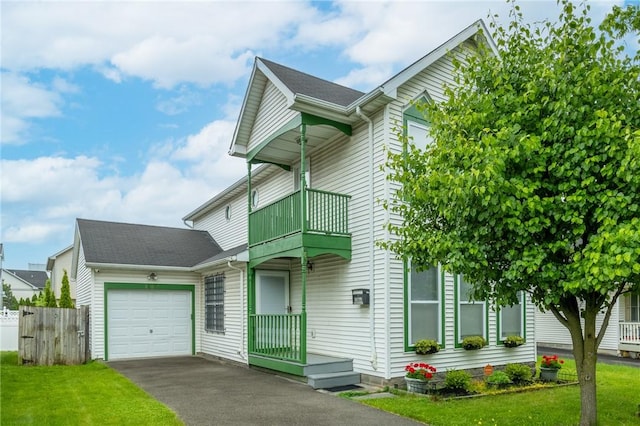 286 Troup St, Rochester, NY 14608 - view of front of house featuring a balcony, a garage, and asphalt driveway