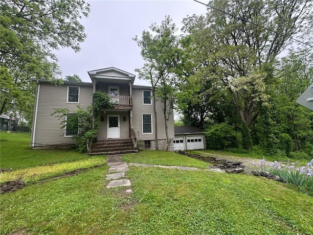 2095 Turnpike Rd, Throop, NY 13021 - view of front facade featuring a balcony, a detached garage, and a front lawn
