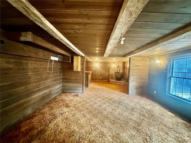 2095 Turnpike Rd, Throop, NY 13021 - interior space featuring wood ceiling with exposed beams, wood walls, carpet flooring, and a wood stove