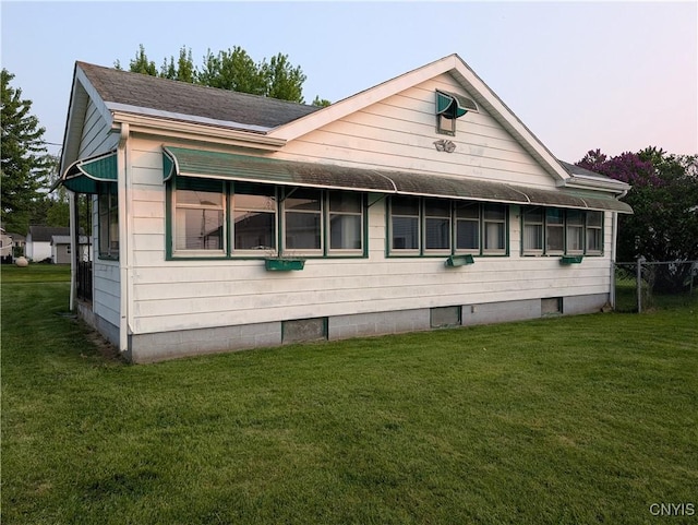 149 Centre St, Cape Vincent, NY 13618 - view of side of home featuring a lawn and a shingled roof