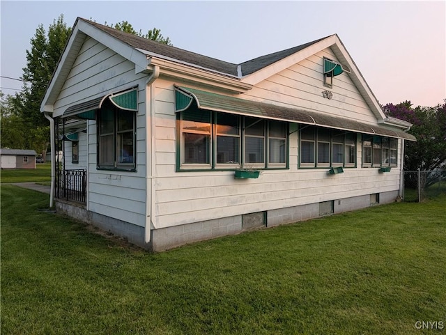 149 Centre St, Cape Vincent, NY 13618 - view of home's exterior with a lawn and a shingled roof