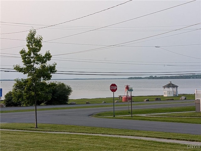 149 Centre St, Cape Vincent, NY 13618 - view of asphalt street featuring traffic signs and a water view