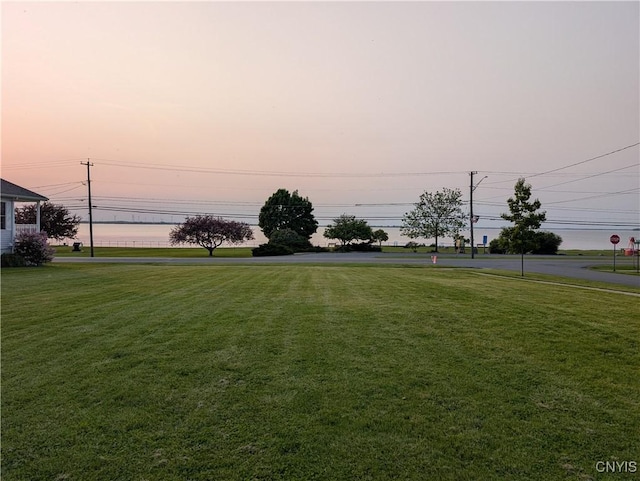 149 Centre St, Cape Vincent, NY 13618 - yard at dusk featuring a lawn
