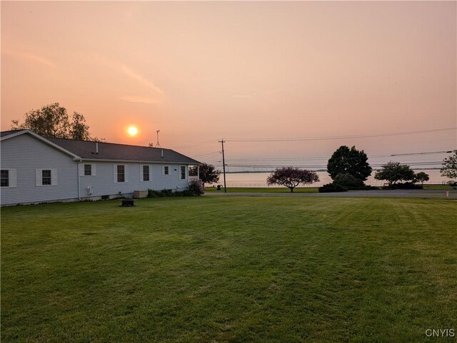 149 Centre St, Cape Vincent, NY 13618 - yard at dusk featuring a lawn