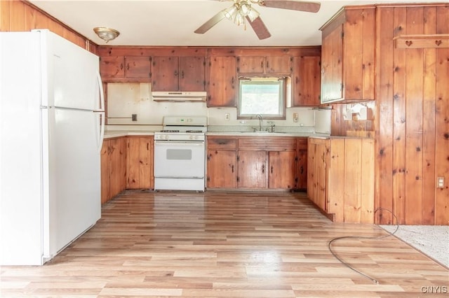 149 Centre St, Cape Vincent, NY 13618 - kitchen with white appliances, under cabinet range hood, light countertops, a ceiling fan, and brown cabinets