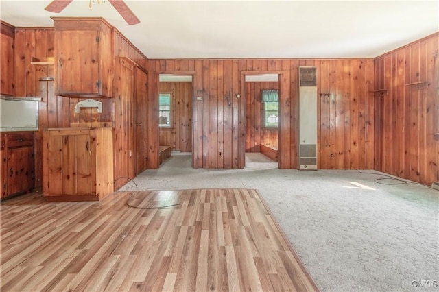 149 Centre St, Cape Vincent, NY 13618 - unfurnished living room featuring a heating unit, wood walls, and ceiling fan