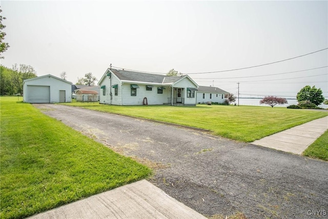 149 Centre St, Cape Vincent, NY 13618 - ranch-style home with an outbuilding, a front yard, driveway, and a garage
