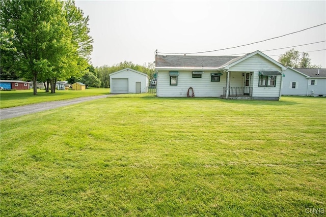 149 Centre St, Cape Vincent, NY 13618 - view of front of home featuring asphalt driveway, an outbuilding, a front lawn, and covered porch