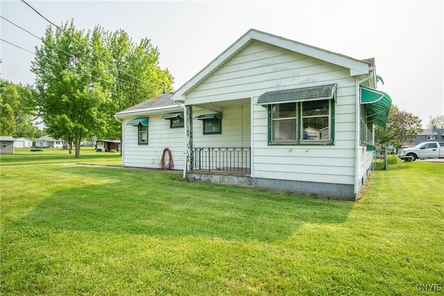 149 Centre St, Cape Vincent, NY 13618 - view of front of house featuring a front lawn and covered porch