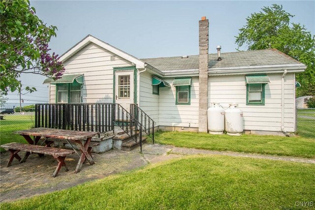 149 Centre St, Cape Vincent, NY 13618 - back of house featuring a chimney and a shingled roof