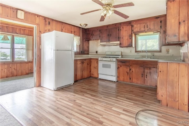 149 Centre St, Cape Vincent, NY 13618 - kitchen with white appliances, under cabinet range hood, light countertops, brown cabinets, and ceiling fan