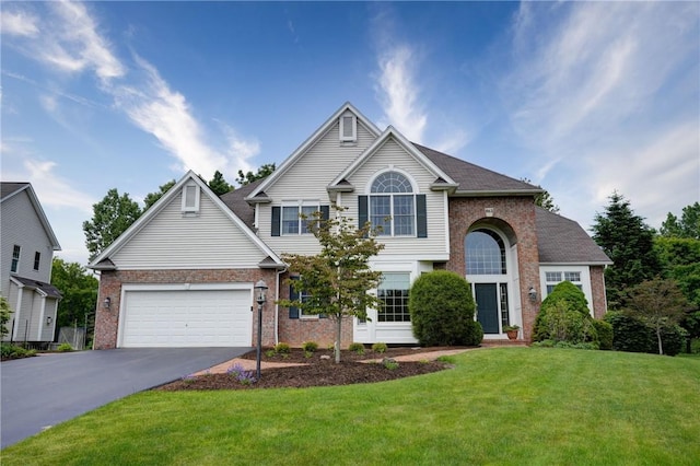 863 Rolins Run, Webster, NY 14580 - traditional-style house with brick siding, driveway, a front yard, and an attached garage