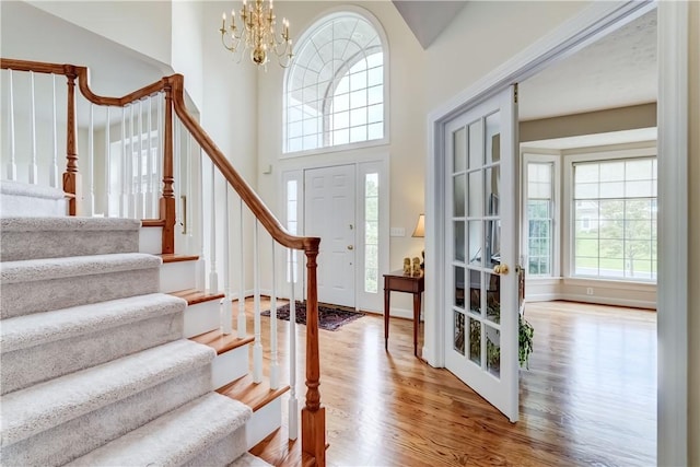 863 Rolins Run, Webster, NY 14580 - entrance foyer featuring healthy amount of natural light, wood finished floors, stairway, and a towering ceiling
