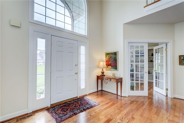 863 Rolins Run, Webster, NY 14580 - entryway with plenty of natural light, a high ceiling, wood finished floors, and french doors