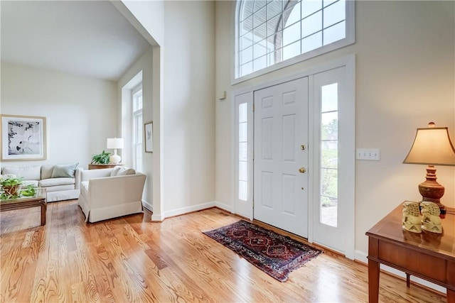 863 Rolins Run, Webster, NY 14580 - entryway featuring healthy amount of natural light, light wood finished floors, baseboards, and a towering ceiling