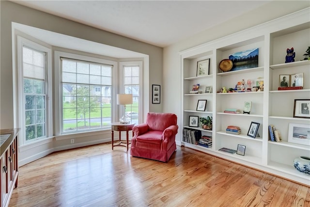 863 Rolins Run, Webster, NY 14580 - sitting room featuring wood finished floors, built in shelves, and baseboards