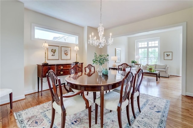 863 Rolins Run, Webster, NY 14580 - dining room featuring healthy amount of natural light, light wood finished floors, a chandelier, and baseboards