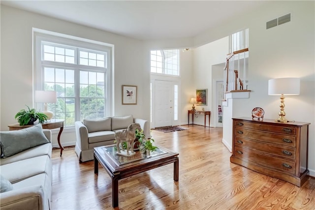 863 Rolins Run, Webster, NY 14580 - living area with light wood-style floors, a high ceiling, and baseboards