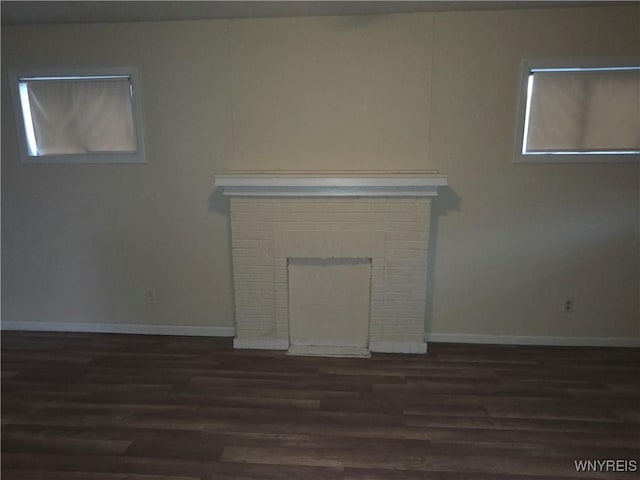 1618 16th St, Niagara Falls, NY 14305 - unfurnished living room featuring dark wood-type flooring, healthy amount of natural light, and baseboards