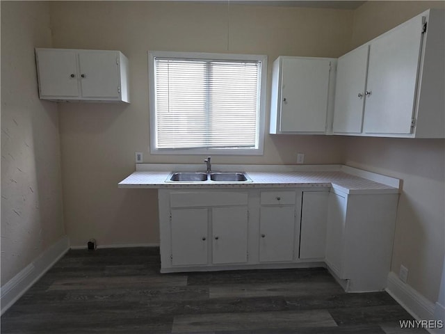 1618 16th St, Niagara Falls, NY 14305 - kitchen featuring a sink, dark wood-style flooring, white cabinetry, and baseboards