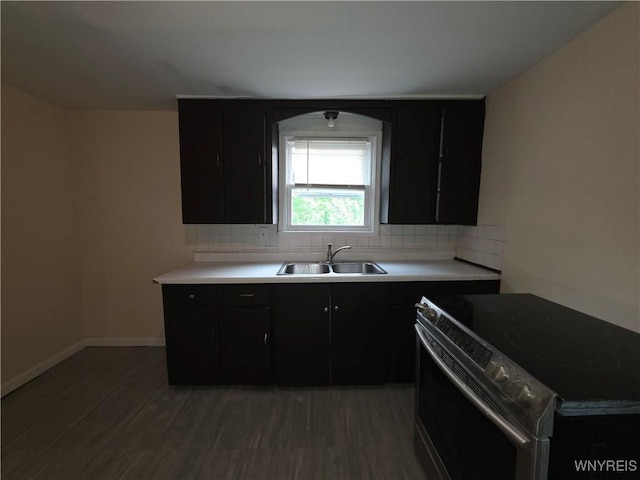 1618 16th St, Niagara Falls, NY 14305 - kitchen with stainless steel electric range oven, a sink, dark cabinets, and decorative backsplash