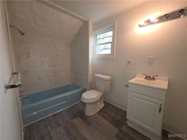 1618 16th St, Niagara Falls, NY 14305 - bathroom featuring toilet, wood finished floors, vanity, tub / shower combination, and vaulted ceiling