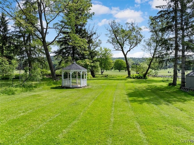 53 University Ave, Hamilton, NY 13346 - view of green lawn with a gazebo and view of wooded area