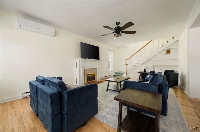 53 University Ave, Hamilton, NY 13346 - living area with a wall unit AC, stairway, a ceiling fan, a baseboard heating unit, and light wood-style flooring