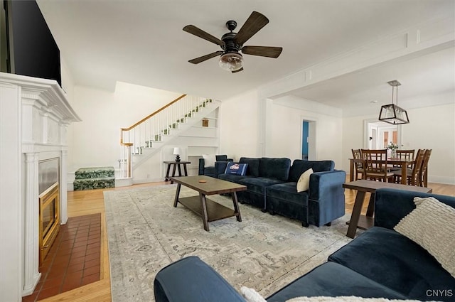 53 University Ave, Hamilton, NY 13346 - living area featuring stairs, wood finished floors, a glass covered fireplace, and ceiling fan