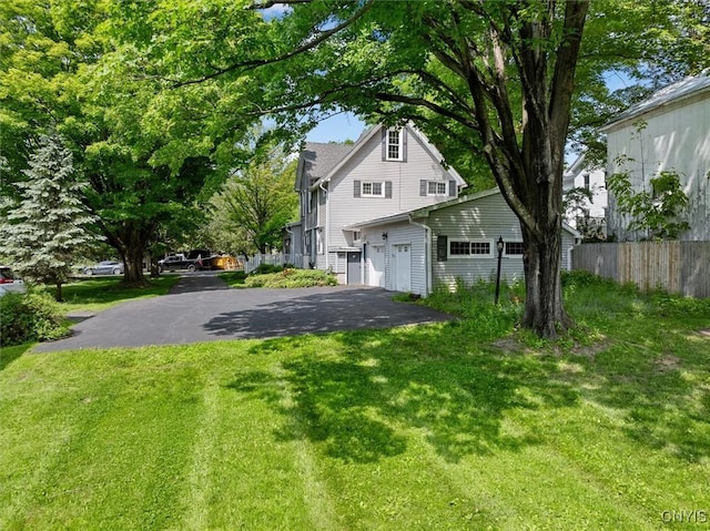 53 University Ave, Hamilton, NY 13346 - view of home's exterior featuring asphalt driveway and a garage