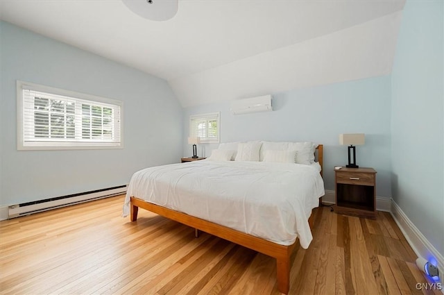 53 University Ave, Hamilton, NY 13346 - bedroom featuring a wall mounted AC, a baseboard heating unit, wood finished floors, vaulted ceiling, and baseboards
