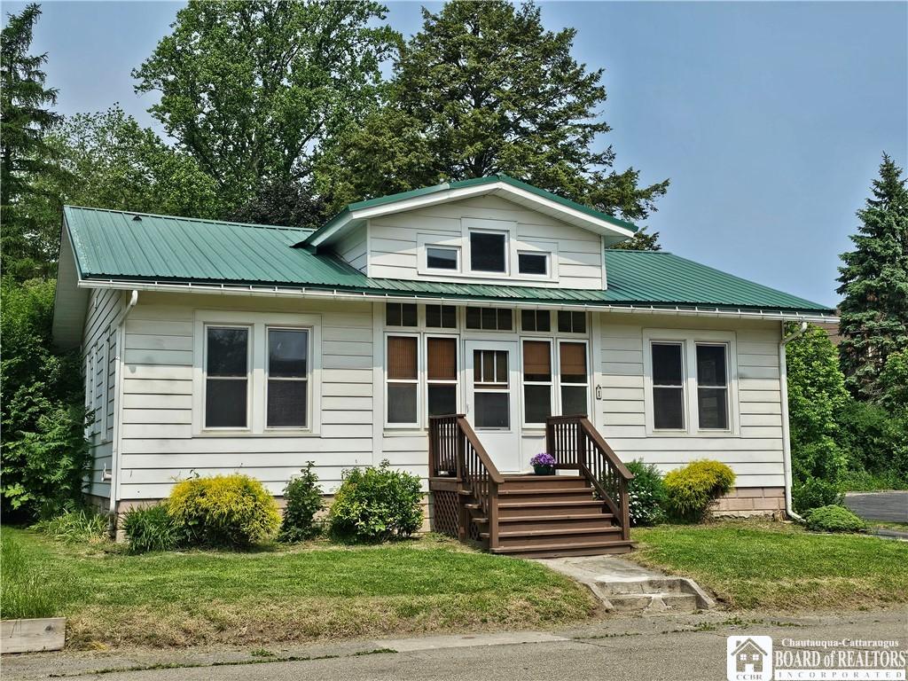 1 Parkway St, Hanover, NY 14136 - bungalow with a front lawn, metal roof, and entry steps
