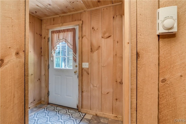 6372 George Hill Rd, Watson, NY 13343 - doorway to outside with wood walls, wooden ceiling, and tile patterned floors