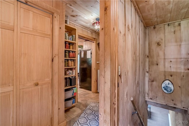 6372 George Hill Rd, Watson, NY 13343 - interior space featuring wooden walls, wood ceiling, and freestanding refrigerator