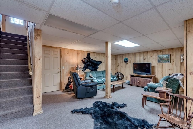 6372 George Hill Rd, Watson, NY 13343 - living area featuring a drop ceiling, carpet flooring, stairs, and wood walls