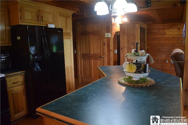 6615 Java Lake Rd, Arcade, NY 14009 - kitchen featuring black fridge with ice dispenser, a chandelier, dark countertops, wood walls, and beamed ceiling