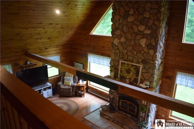 6615 Java Lake Rd, Arcade, NY 14009 - living room with wooden walls, wood finished floors, and a glass covered fireplace
