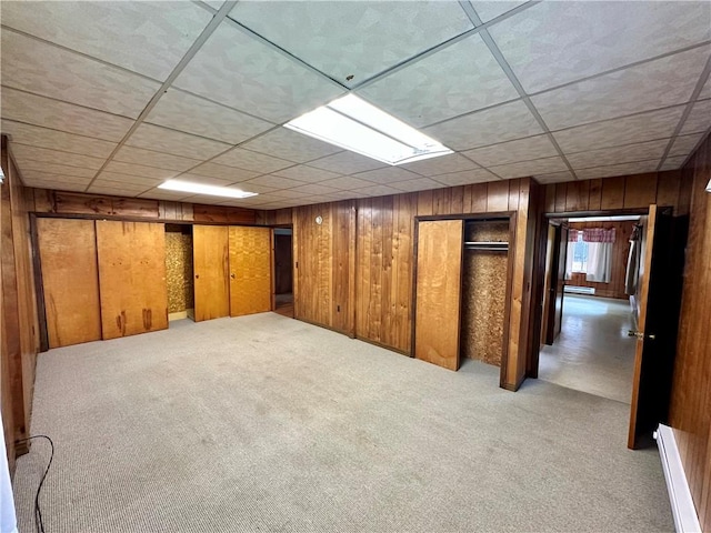 6956 E Washington St, Bath, NY 14810 - basement featuring wooden walls, carpet, and a drop ceiling