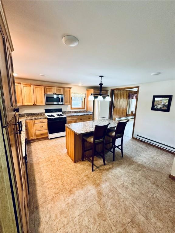 6956 E Washington St, Bath, NY 14810 - kitchen featuring white range, stainless steel microwave, a baseboard radiator, a kitchen island, and light stone counters
