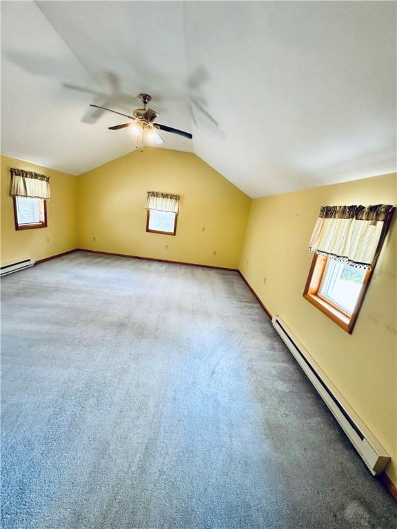 6956 E Washington St, Bath, NY 14810 - empty room featuring a baseboard heating unit, baseboard heating, carpet flooring, ceiling fan, and lofted ceiling