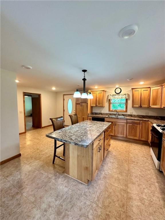 6956 E Washington St, Bath, NY 14810 - kitchen with range with gas stovetop, a sink, dark stone counters, a center island, and dishwasher