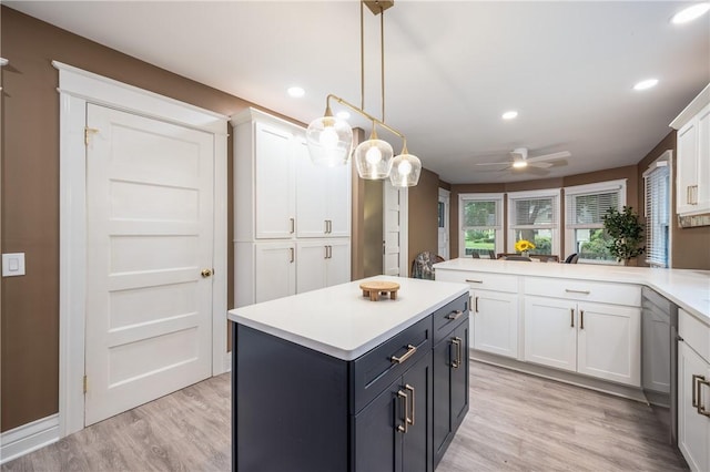 40 Washington Rd, Pittsford, NY 14534 - kitchen with white cabinets, light countertops, a ceiling fan, light wood finished floors, and a kitchen island