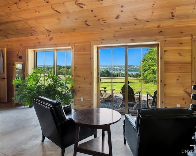 4500 W Lake Rd, Niles, NY 13152 - dining area with wood walls and concrete floors