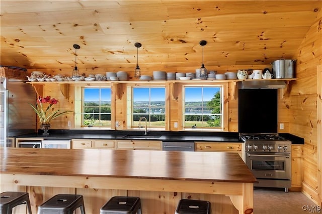 4500 W Lake Rd, Niles, NY 13152 - kitchen with butcher block counters, high end range, a sink, and a breakfast bar